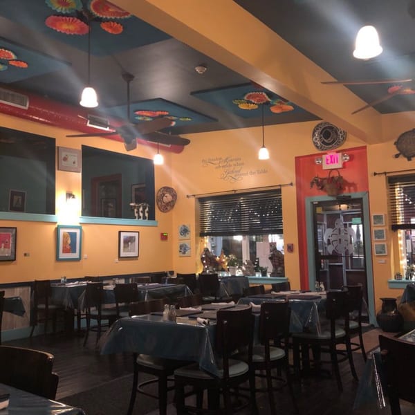 The vibrant interior of Tortuga's Mexican Village restaurant with colorful decor and set tables.