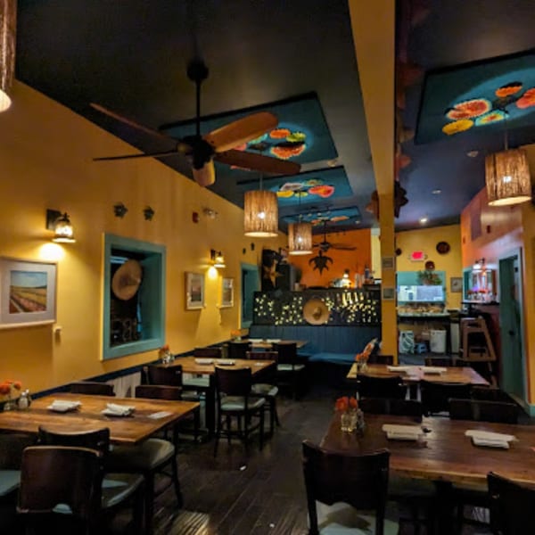 Interior of Tortuga's Mexican Village, featuring colorful walls, wooden tables, and decorative lighting.